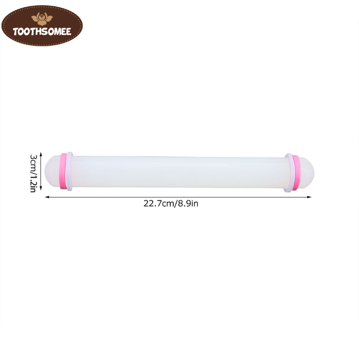 Small plastic fondant rolling pin on a kitchen counter next to rolled fondant