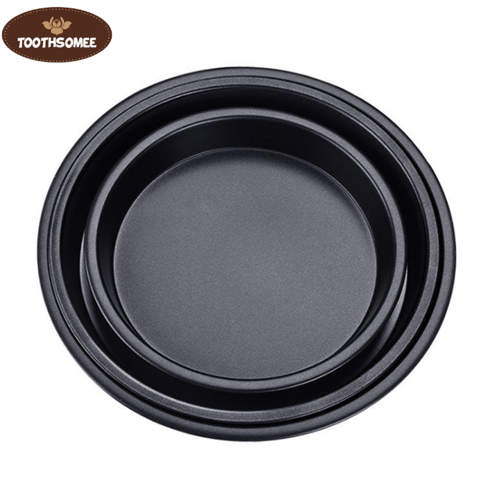 Set of three non-stick round pizza pans in different sizes placed on a kitchen counter