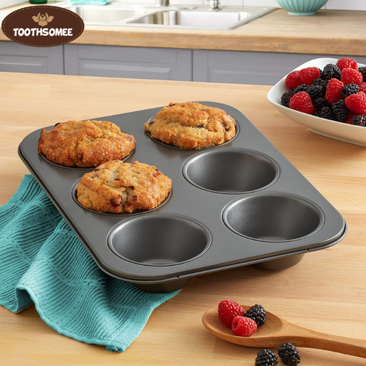 Non-stick 6-cup muffin tray with freshly baked muffins placed on a kitchen counter