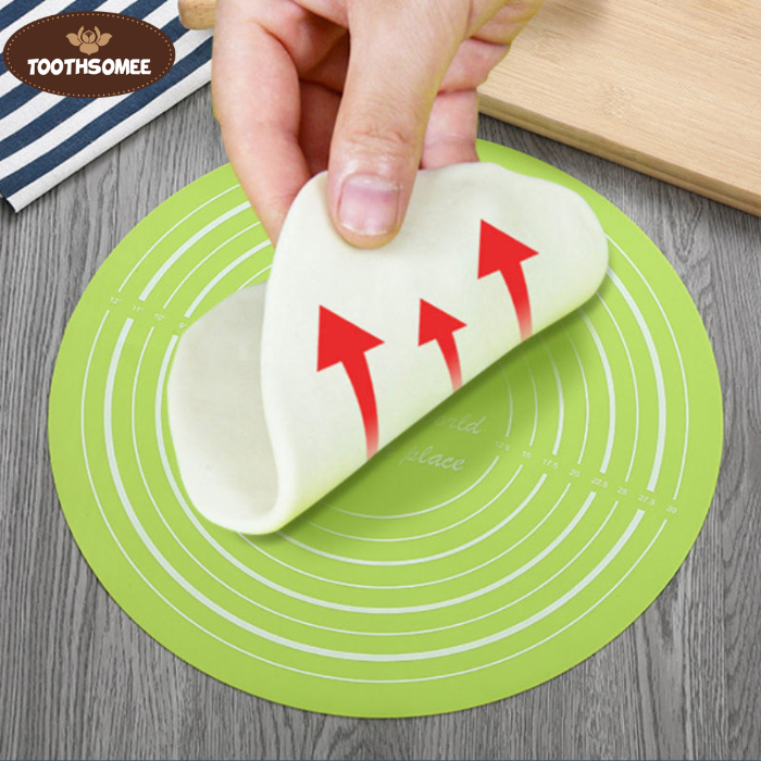 Round silicone baking mat with printed measurements used for rolling dough