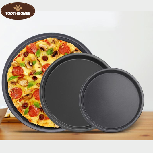 Set of three non-stick round pizza pans in different sizes placed on a kitchen counter