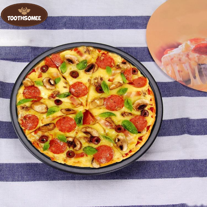 Set of three non-stick round pizza pans in different sizes placed on a kitchen counter